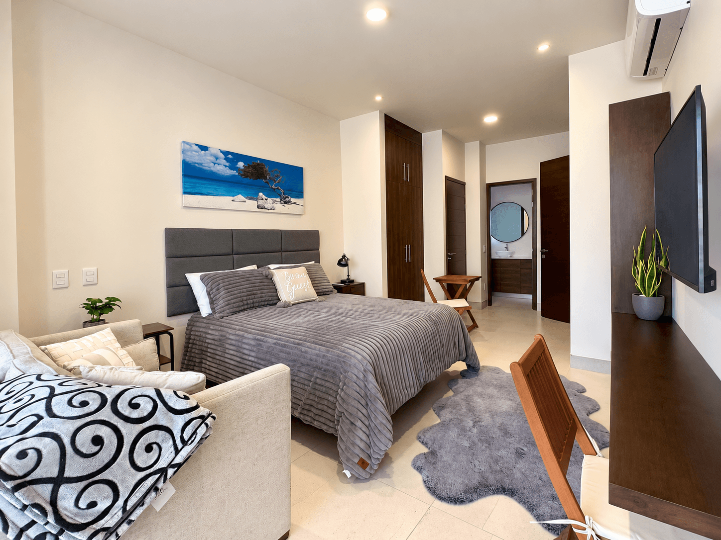 Studio with bed, sofa, and closet in a compact, functional layout.