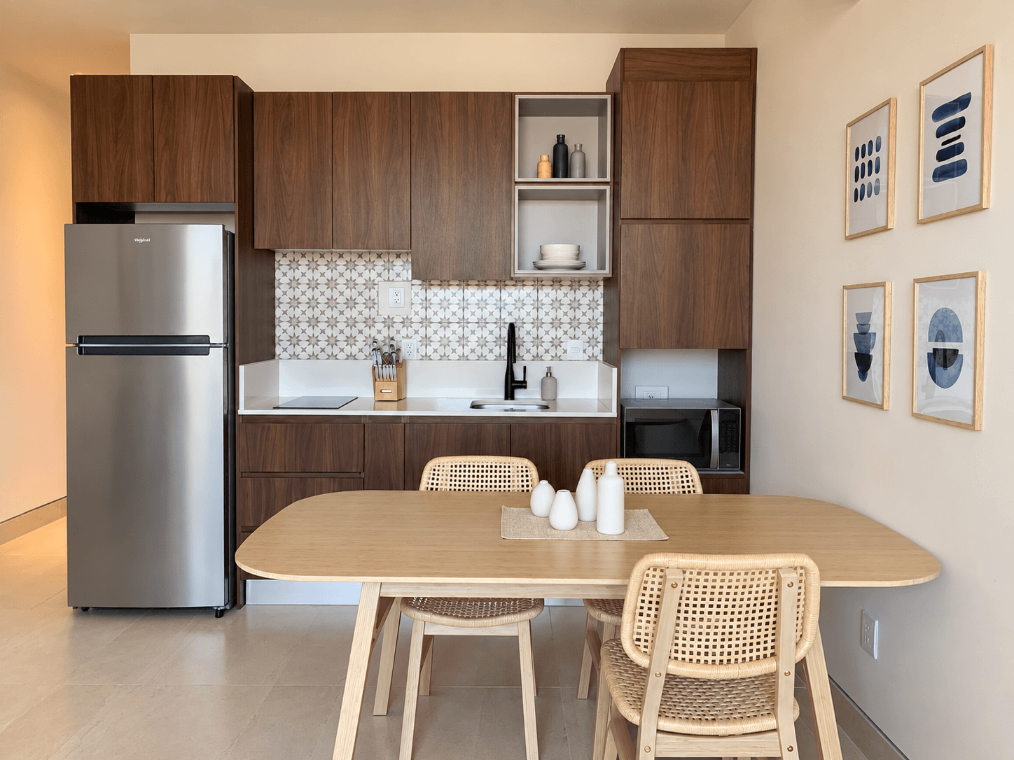 Equipped kitchenette with fridge, microwave, and built-in cooktop.