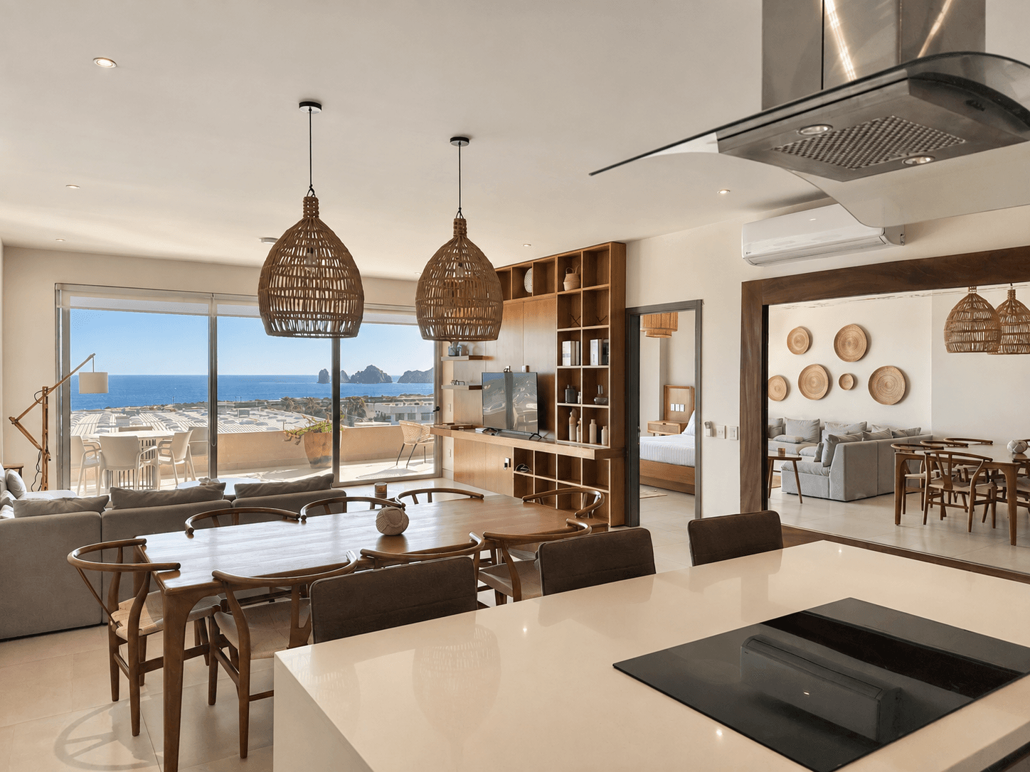Dining area with woven pendant lamps and direct ocean views.