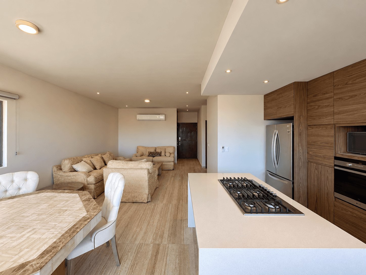 Living and dining area with kitchen island in open-concept layout.