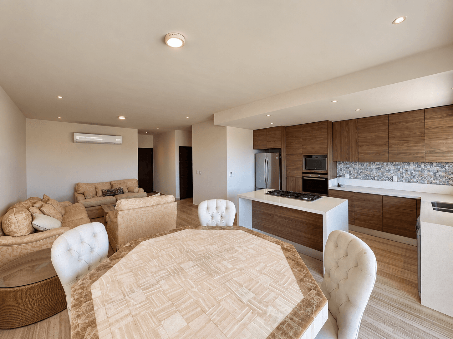 Dining area with view into fully integrated wood-finish kitchen.