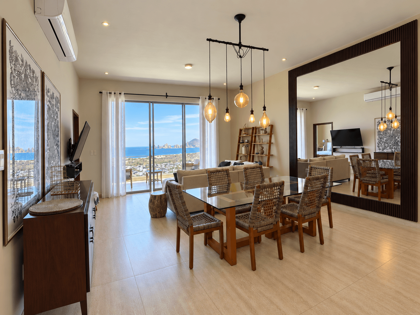Integrated living and dining space with terrace access and ocean views.
